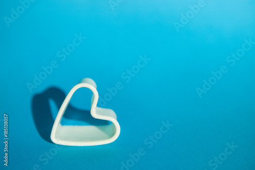 White heart on blue background with copy space