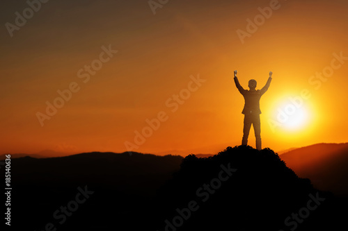 Businessman raise arms up in victory moment. Concept of victory, success or winning in business. 