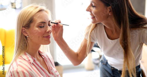Makeup artist applies eye shadow. Perfect makeup