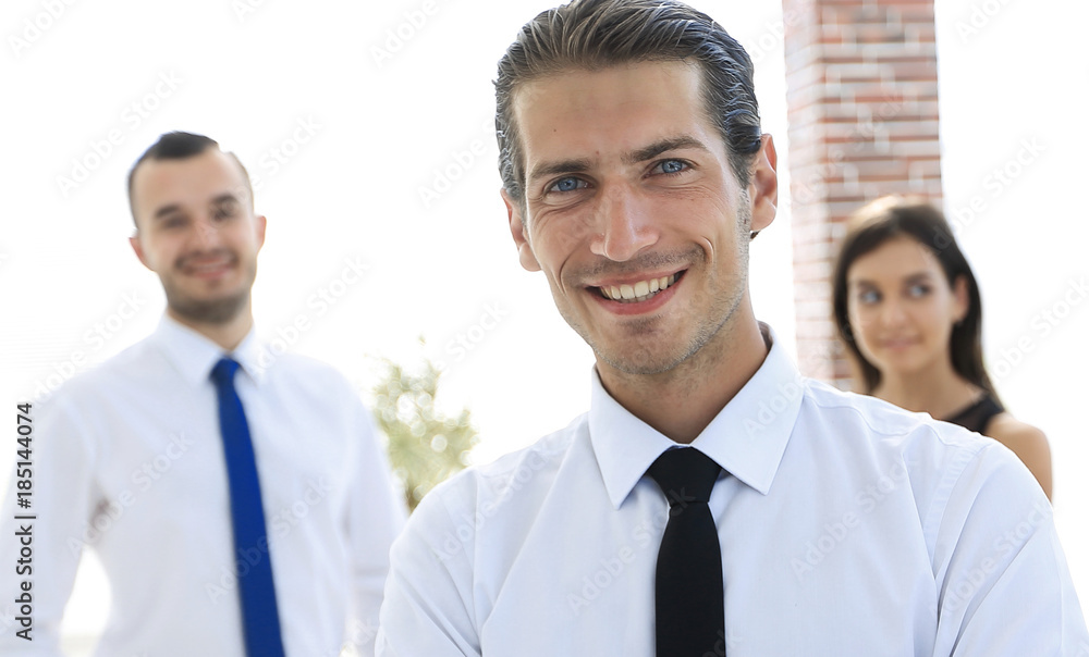 portrait of a successful business person on the background of colleagues. portrait of a successful business person on the background of colleagues.