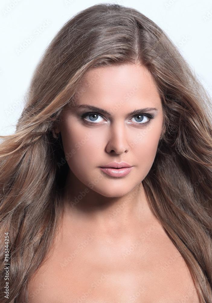 Studio shot of a beautiful young woman with perfect skin against Studio shot of a beautiful young woman with perfect skin against