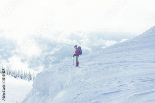 Winter hiking in the mountains on snowshoes with a backpack and tent.