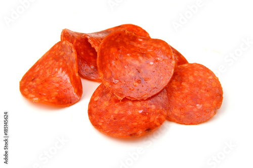 Clices of pepperoni on white background photo