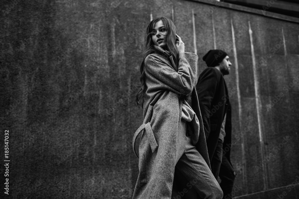 Beautiful couple in stylish clothes in gray tones, city Beautiful couple in stylish clothes in gray tones, city