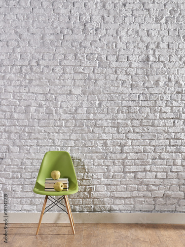 Fototapeta zielone krzesło na tle ceglanej ściany