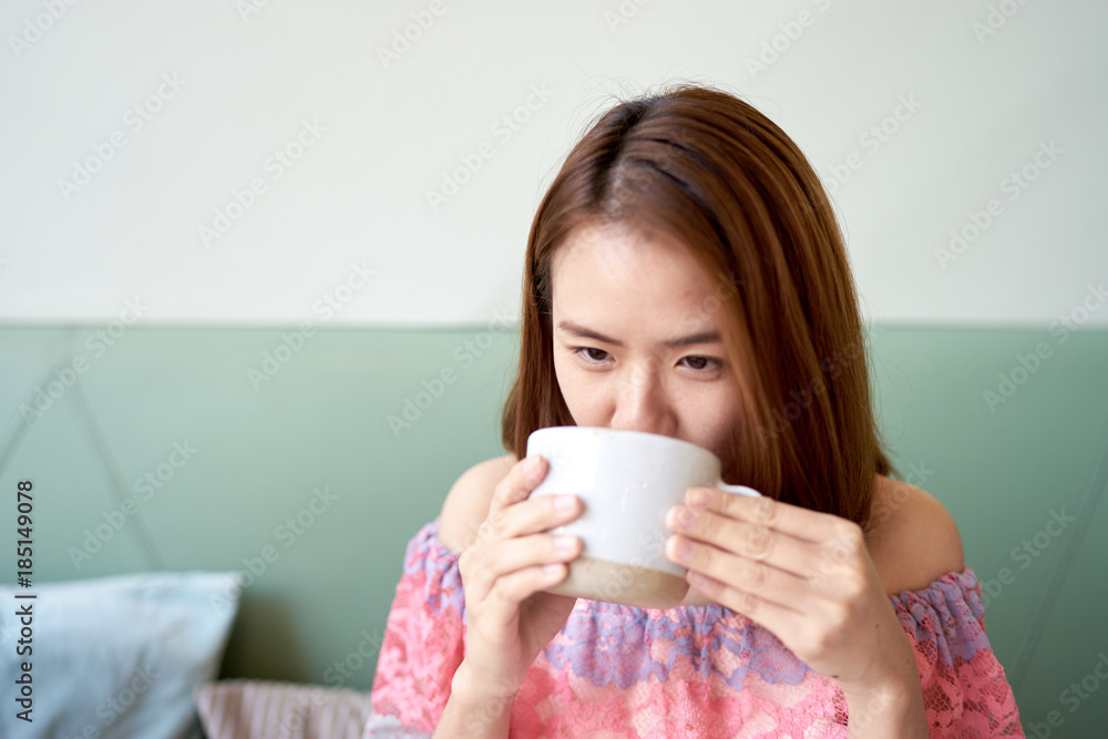 Portrait of a beautiful young asian woman drinking coffee at cafe Portrait of a beautiful young asian woman drinking coffee at cafe
