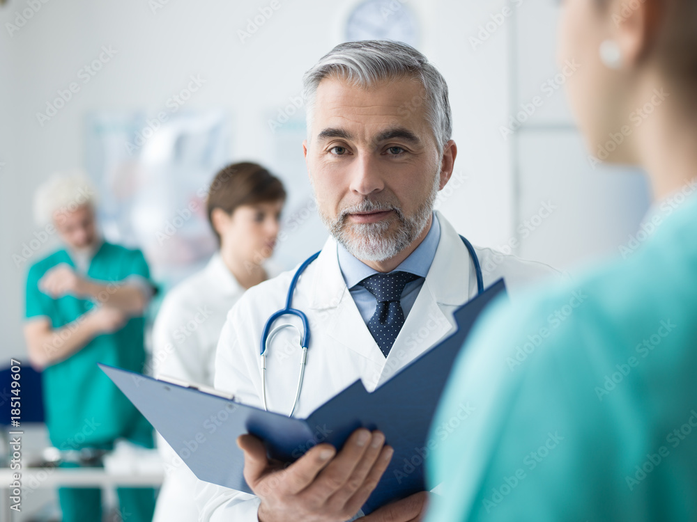 Doctor examining a patient's medical records Doctor examining a patient's medical records