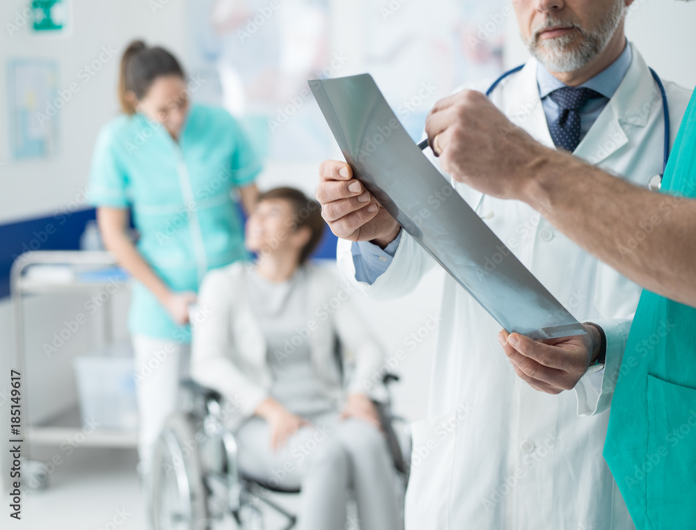 Fototapeta premium Professional doctors examining patient's x-ray