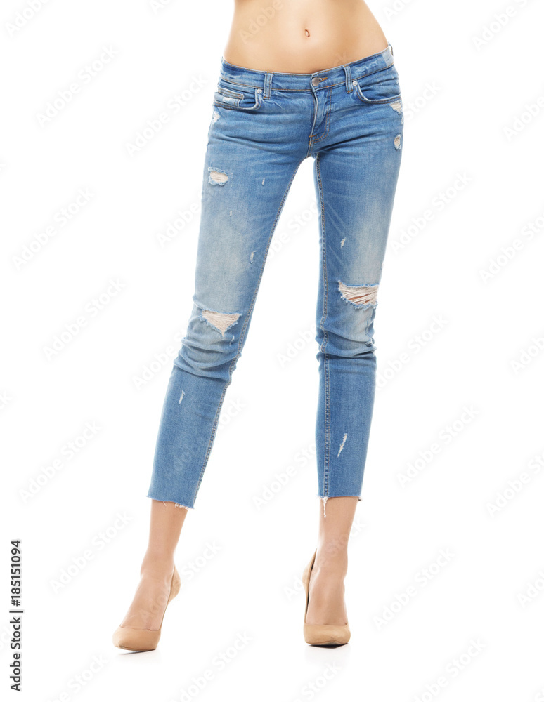 Slim and sexy female legs in jeans isolated on white.