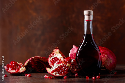 Pomegranate and a bottle of juice.