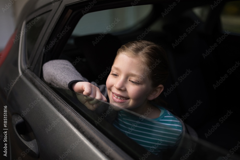 Teenage girl looking through car window Teenage girl looking through car window