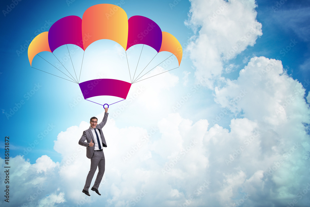 Young businessman falling on parachute in business concept Young businessman falling on parachute in business concept
