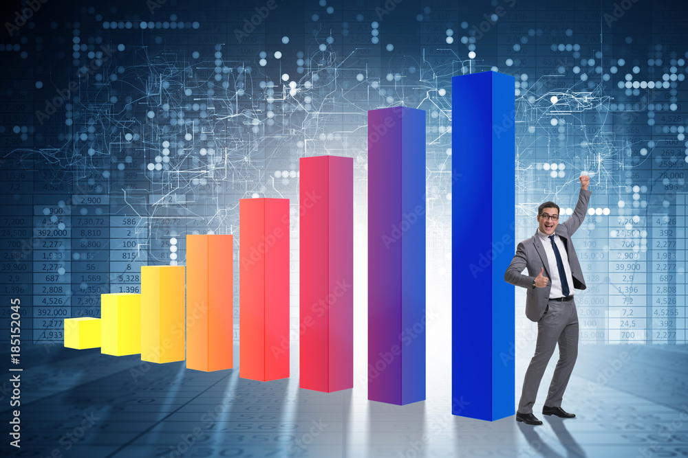 Young businessman in business concept with bar charts Young businessman in business concept with bar charts