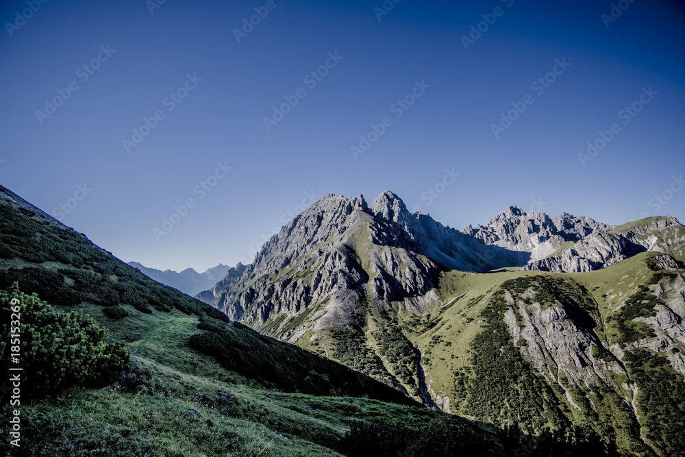 Look on ah mountain with a grassland in the front Look on ah mountain with a grassland in the front