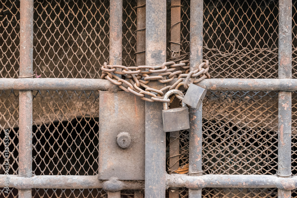 Closed bars with old chain and lock Closed bars with old chain and lock