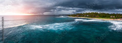 Panorama of the surf spot named Coconut with surfers on the line up. Stormy weather surfing conditions