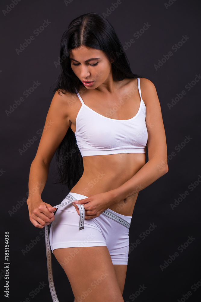 Young beautiful woman in white fitness clothing Young beautiful woman in white fitness clothing