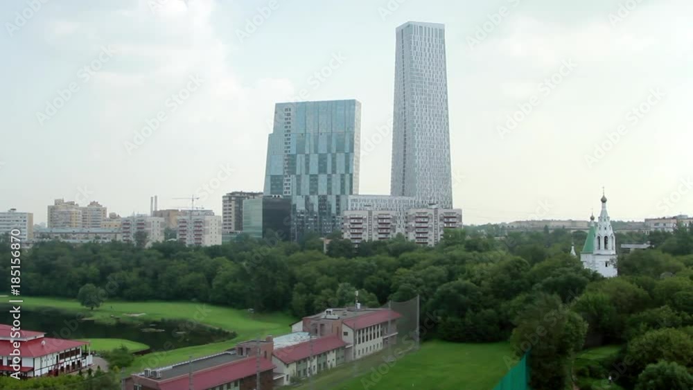 Golf club in city on background of houses in Moscow. Lifestyle of urban people. Green nature in megacity. Golf club in city on background of houses in Moscow. Lifestyle of urban people. Green nature in megacity.