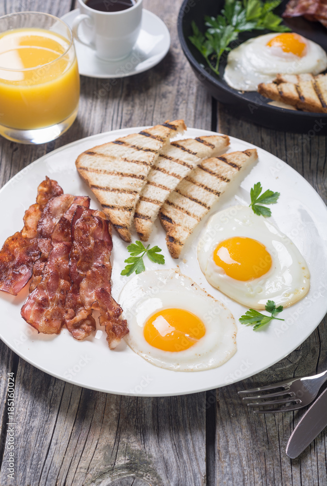 Breakfast with eggs bacon and toasts Breakfast with eggs bacon and toasts
