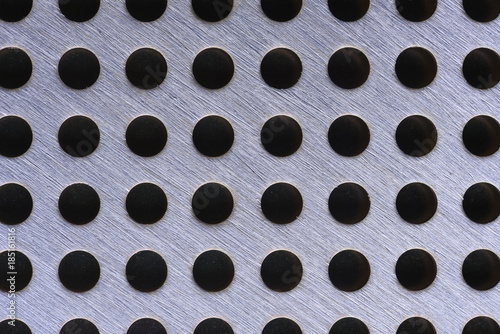 Close up of metal background texture with holes