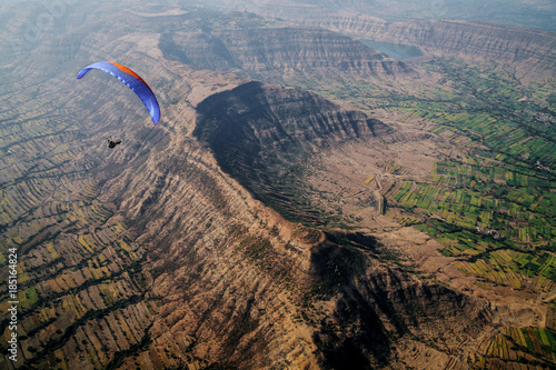Paragliding pilot over mountains in India