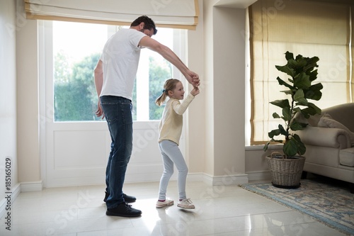 Father and daughter having fun in living room
