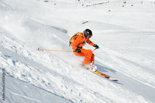Ski athlete in a fresh snow powder rushes down the snow slope © yanik88