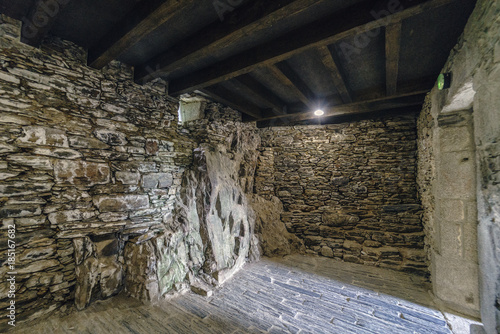 Interior of a stone building built on rock in the ancient monastery of Caaveiro dating from the tenth century and which hosted hermits of the area, in Galicia, Spain © peizais