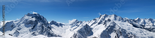 Fototapeta Panoramic view of snow-capped mountain peaks