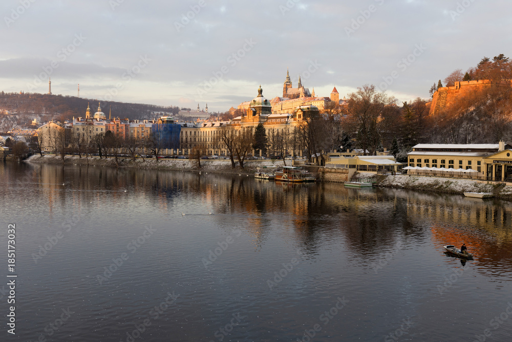 Early Morning Christmas snowy Prague Lesser Town with gothic Castle above River Vltava, Czech republic