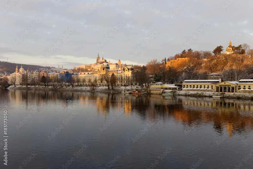 Early Morning Christmas snowy Prague Lesser Town with gothic Castle above River Vltava, Czech republic