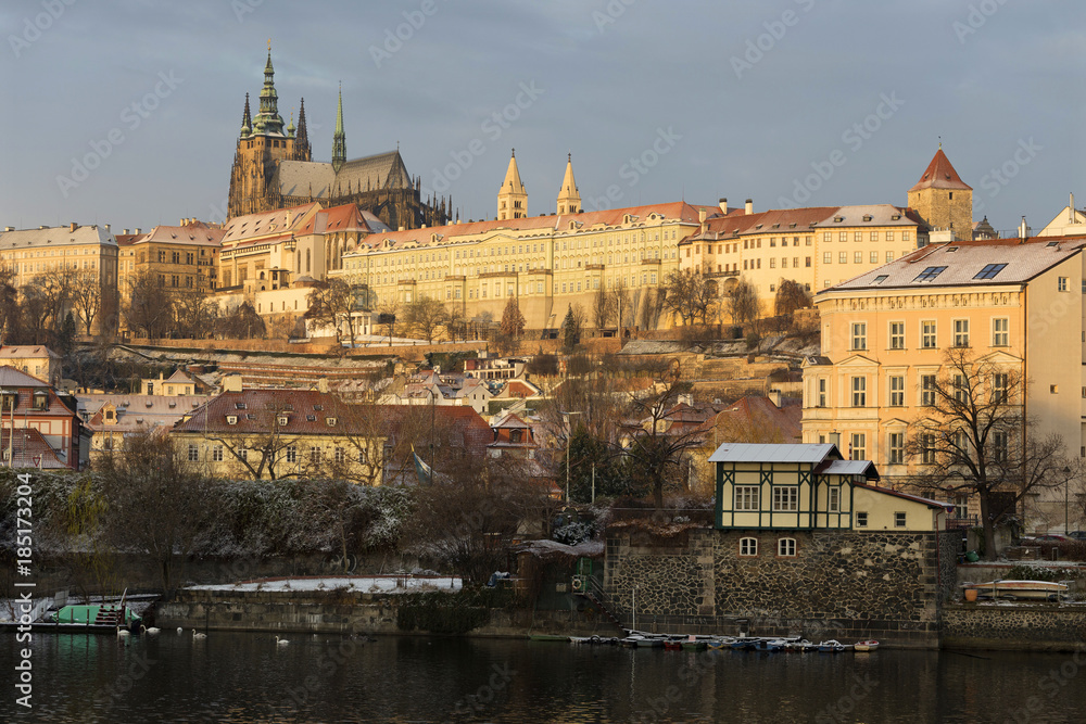 Fototapeta premium Early Morning Christmas snowy Prague Lesser Town with gothic Castle above River Vltava, Czech republic