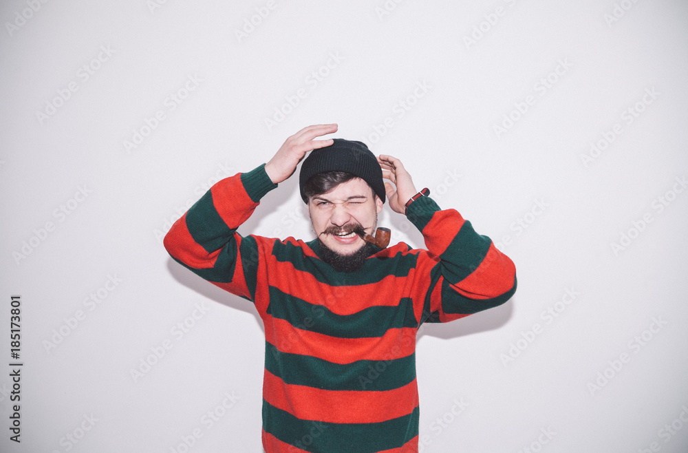 boy wearing bobble hat and smoking tobacco pipe boy wearing bobble hat and smoking tobacco pipe