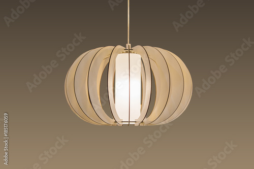 Картината върху платно Suspended wooden lamp isolated on a brown background