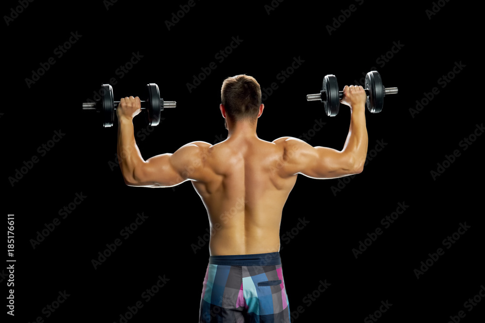 Athlete making exercises with dumbbells. Building perfect biceps by lifting weight. Strong and muscular body. Athlete making exercises with dumbbells. Building perfect biceps by lifting weight. Strong and muscular body.