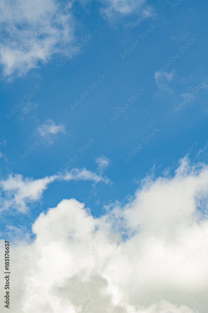 The vertical view of light blue sky with white clouds for background or texture. Copy space