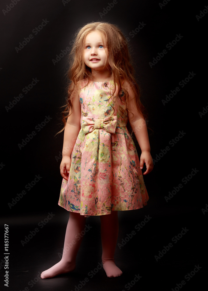 Little girl on a black background Little girl on a black background