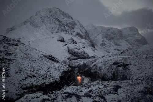 Car moving on the mountain road against snowcapped mountain