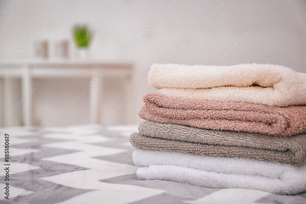 Clean bath towels on bed in hotel suite Clean bath towels on bed in hotel suite