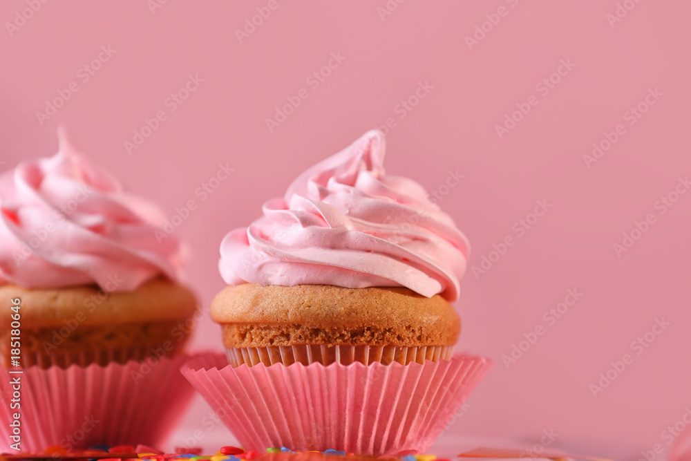 Delicious cupcakes on color background, closeup Delicious cupcakes on color background, closeup
