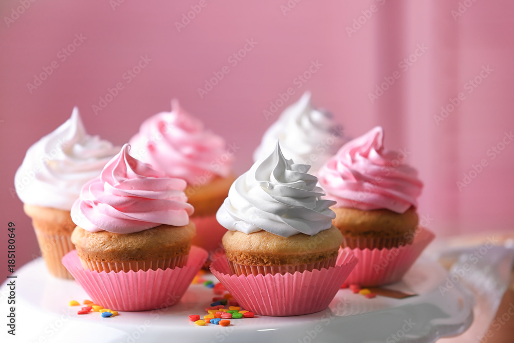 Dessert stand with delicious cupcakes on blurred background Dessert stand with delicious cupcakes on blurred background