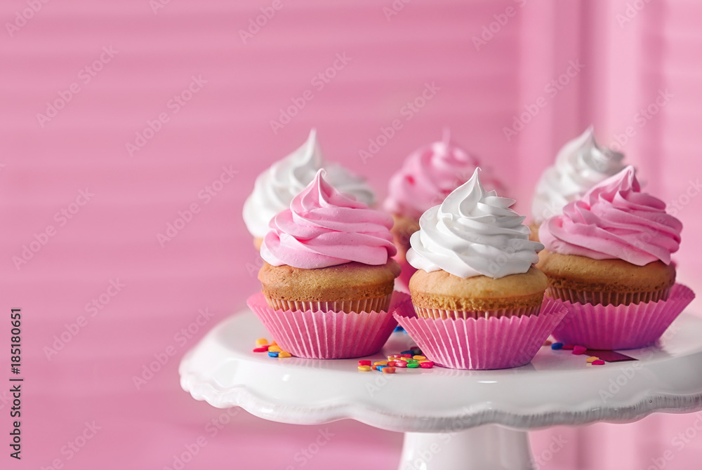 Dessert stand with delicious cupcakes on blurred background