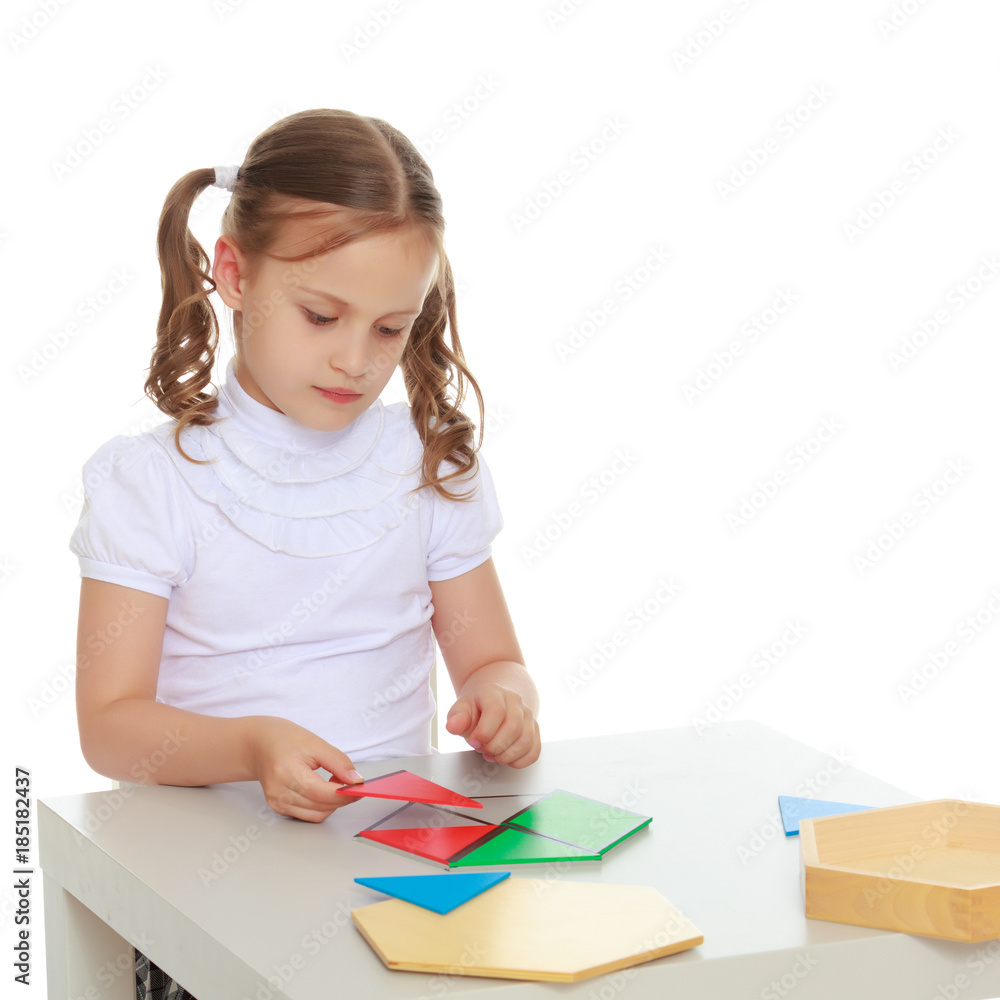 A little girl is studying Montessori stuff. A little girl is studying Montessori stuff.