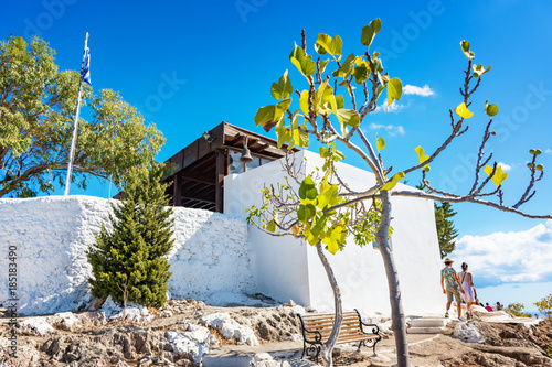 Couple walking round Tsambika Monastery, (RHODES, GREECE) photo