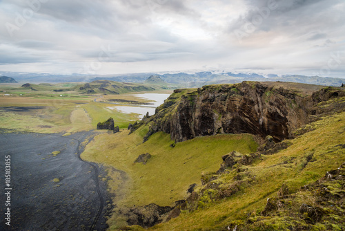 Scenic, landscape view of mountains, glaciers, lakes, and a beach in Iceland. 