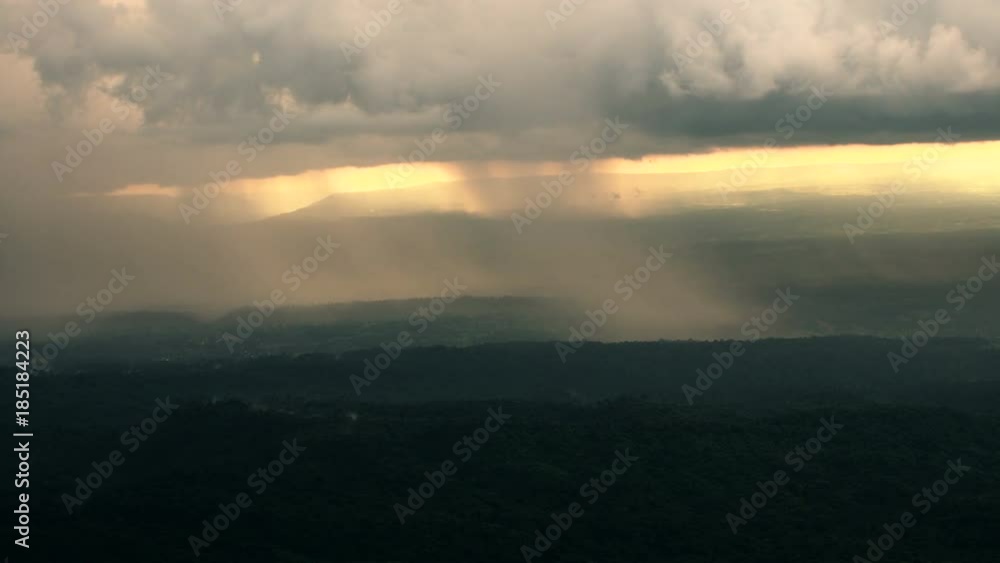 The rain cloud raining over the tropical mountain in sunset time at Phu Hin Rong Kla National Park , Thailand. The rain cloud raining over the tropical mountain in sunset time at Phu Hin Rong Kla National Park , Thailand.