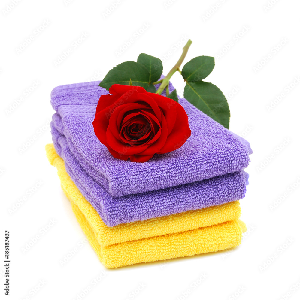 Stack of colorfull towels closeup and rose flower Stack of colorfull towels closeup and rose flower