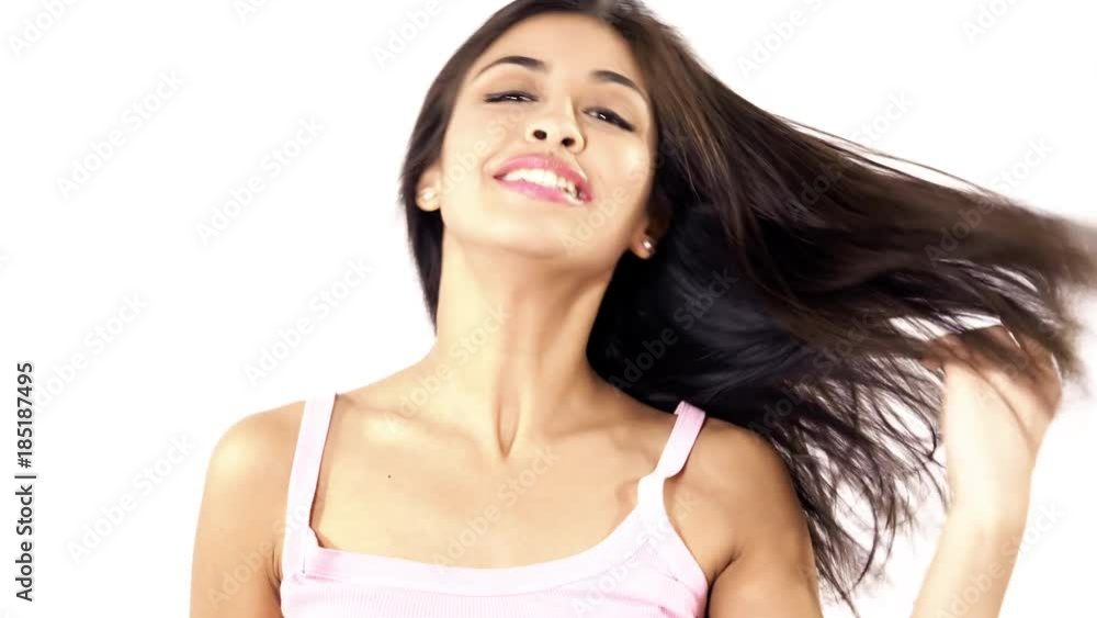 Cute young latino woman shaking long silky hair isolated 4K slow motion Cute young latino woman shaking long silky hair isolated 4K slow motion