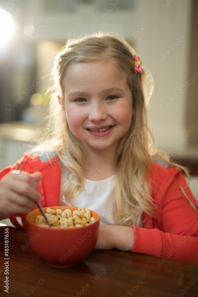 Young girl having breakfast in the kitchen at home Young girl having breakfast in the kitchen at home