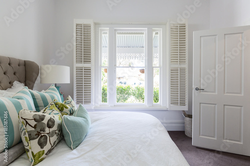 Bedroom window with a garden view in a luxury country house bedroom photo
